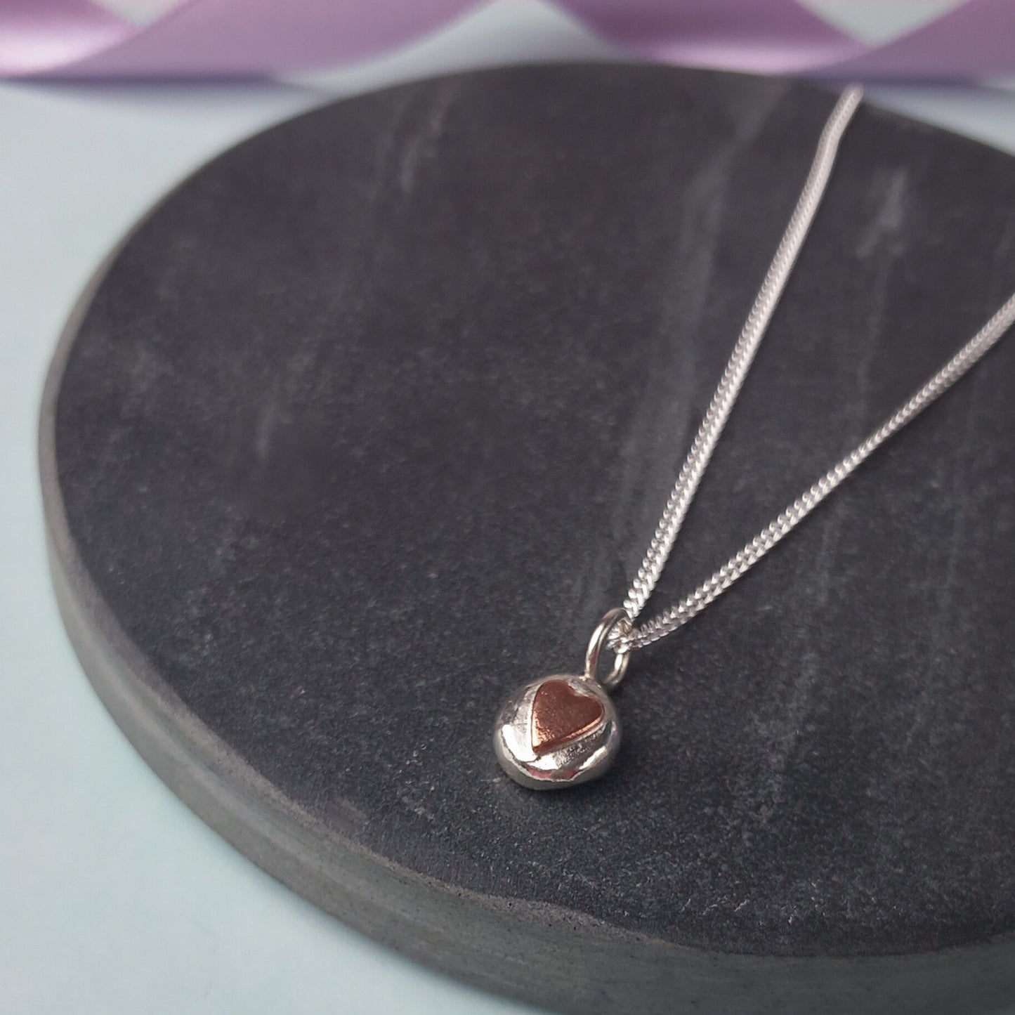 Solid Silver Pebble pendant with Copper Heart.